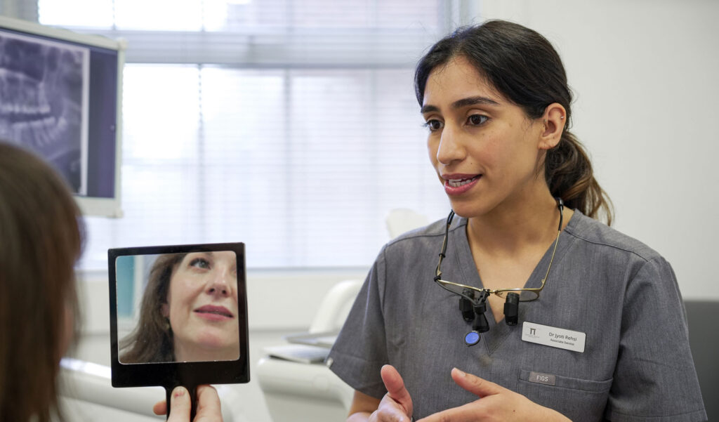 dentist with patient talking with mirror