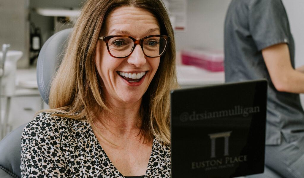 happy customer with great teeth looking in a mirror